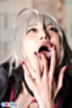 Mizuki raising a hand to her lips cum in her mouth