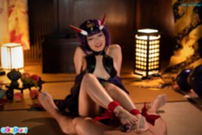 Aika Suzumiya seated giving footjob with bare feet