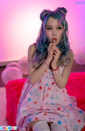 Ria Kurumi sitting on sofa in dress sucking cock and lollipop