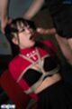 Leaning back on chair tied with rope mouth open