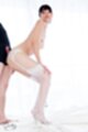 Giving assjob in white stockings hands on knees garter belt wearing high heels