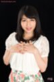 Hands clasped on her chest
