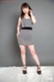 Standing with hand on hip wearing high heels