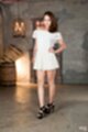 Wearing white dress hand on hip in high heels