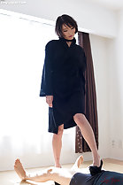 Wearing black robe looking down in high heels man prone rubbing cock through shorts