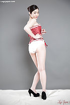 Wearing basque looking over her shoulder wearing panties in high heels