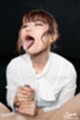 Eyes closed head back cum dripping from her tongue giving handjob