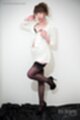 Wearing jacket knee raised in black stockings high heels
