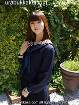 Long haired kogal standing in garden wearing uniform